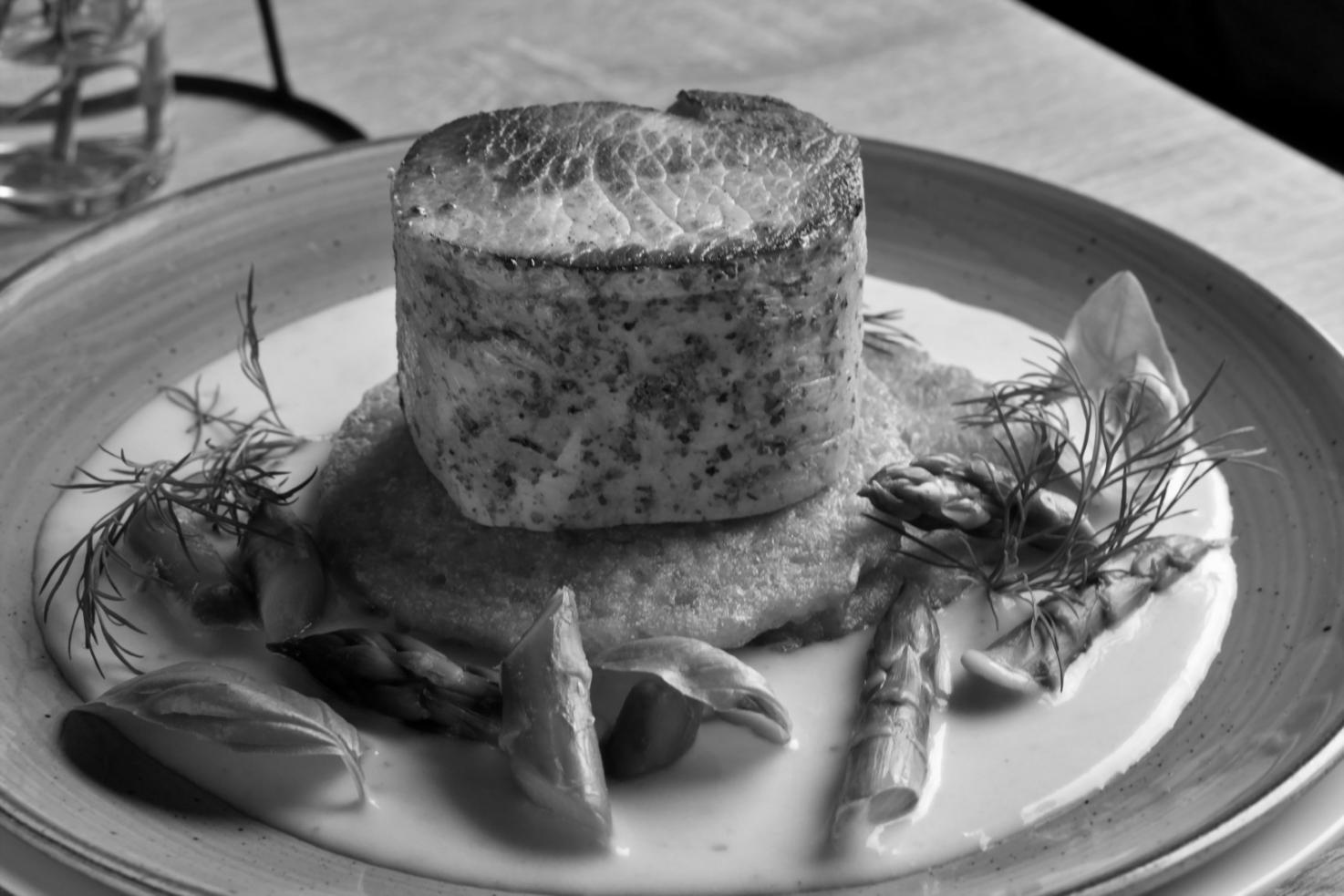 Modern culinary workspace with natural lighting and professional plating stations